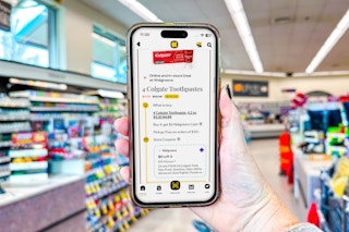 hand holding smartphone in a store