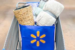 blanket, trash can, curtains, and wash cloths in a Walmart reusable bag