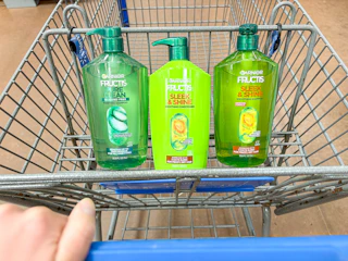3 garnier shampoo and conditioner bottles sitting in a walmart cart