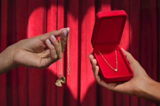 someone trading a locket for a diamond necklace