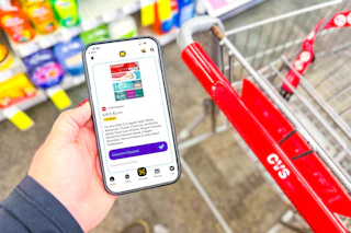 hand holding a smartphone displaying a 1-clip coupon offer in the kcl app