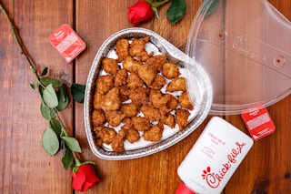 chick fil a heart chicken nugget tray with sauce and roses on a table 
