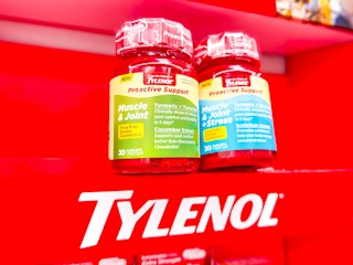 Two Proactive Support bottles over Tylenol sign on a display in Walmart store