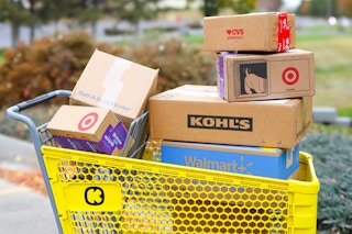 a KCL themed cart filled with shipping boxes from different retailers