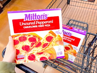 hand holding miltons pizza