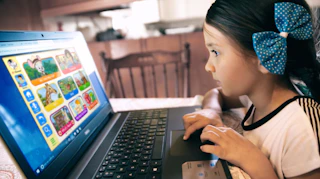A child and parent looking at ABCmouse on a computer. 
