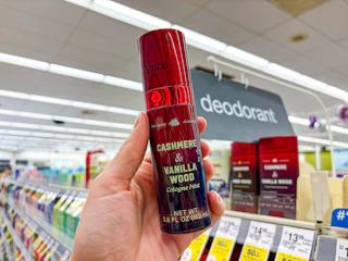 hand holding old spice alchemist cologne in walgreens