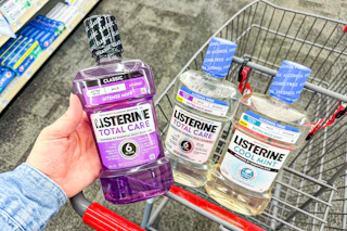 hand holding a bottle of listerine mouthwash