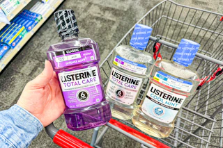 hand holding a bottle of listerine mouthwash
