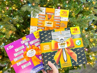 3 Bic Razor Gift Sets held in front of Christmas tree