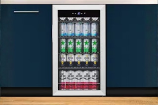 the Tylza Beverage Refrigerator installed in a kitchen with blue cabinets 