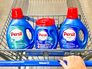 Three Persil laundry products in the front seat of a Walmart shopping cart