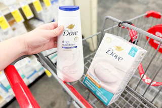 hand placing a dove body wash bottle into a cart next to dove bar soap