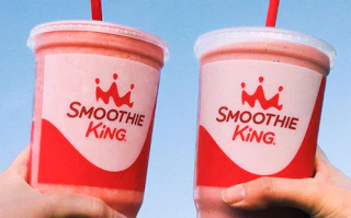 two people holding smoothie king cups. taken from their instagram