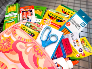 school supplies sitting in a backpack in a walmart cart