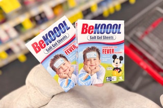 person holding 2 boxes of be koool fever cooling sheets