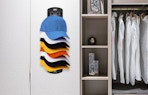 a hat organizer on a wall of a closet