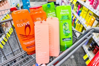 loreal elvive, garnier fructis, and monday shampoo in a cart