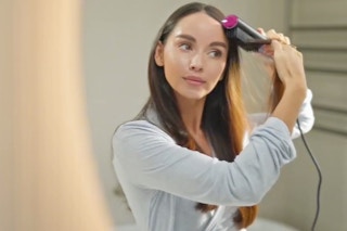 a woman using a hair straightener