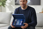 a man holding the harry's plus gift set