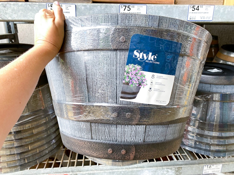 hand holding barrel planter on lowes shelf