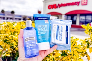 hand holding neutrogena cleansers and wipes outside of a cvs store